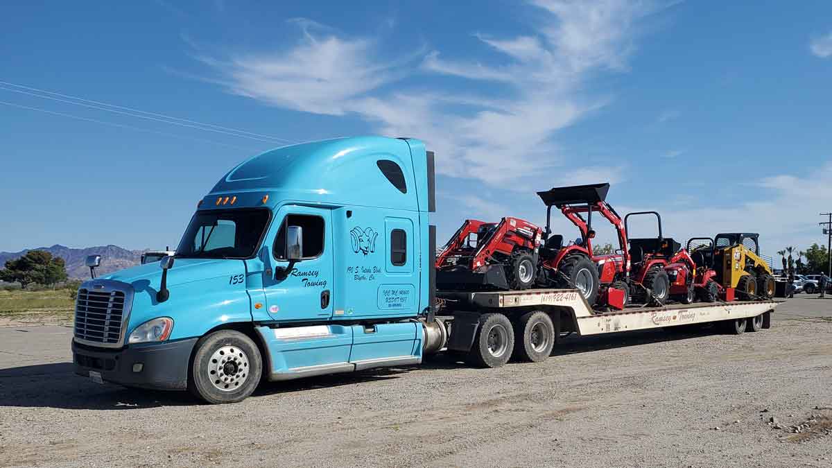 Ramsey Towing hauling multiple bobcat machinery